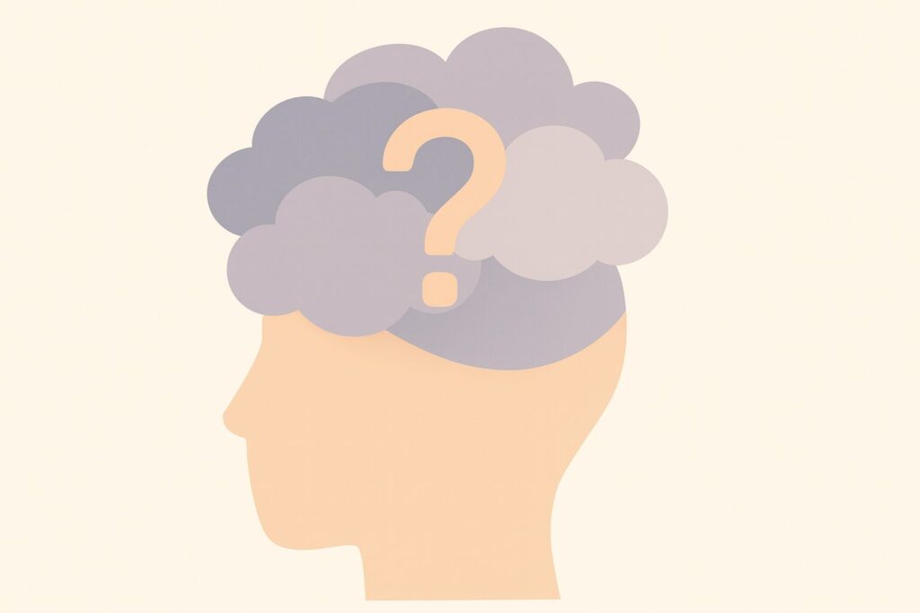 頭の中にモヤモヤした雲と大きなクエスチョンマークが描かれた、人の横顔のシルエットイラスト
